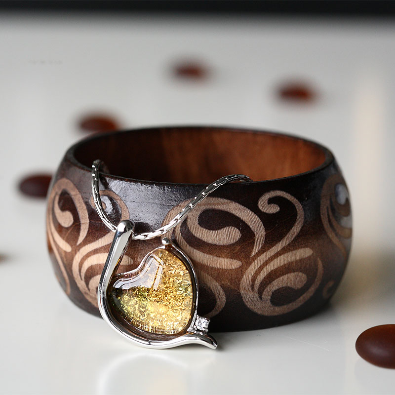 Elegant sølvfarget armbånd innlagt med glassanheng